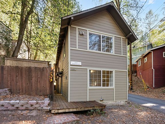 Front of home with private entrance and small storage shed on the left