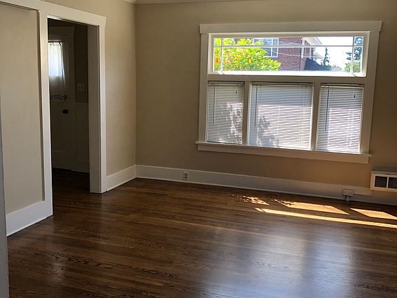 Living room and entry with hardwood floors throughout