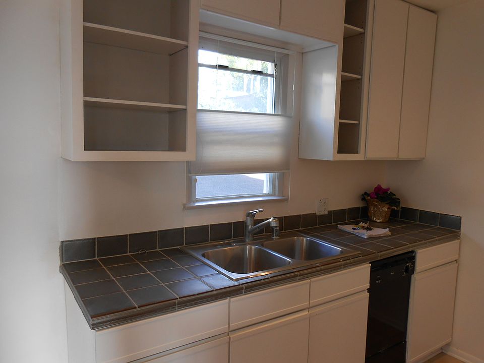 New, pewter retro tile counter tops in kitchen