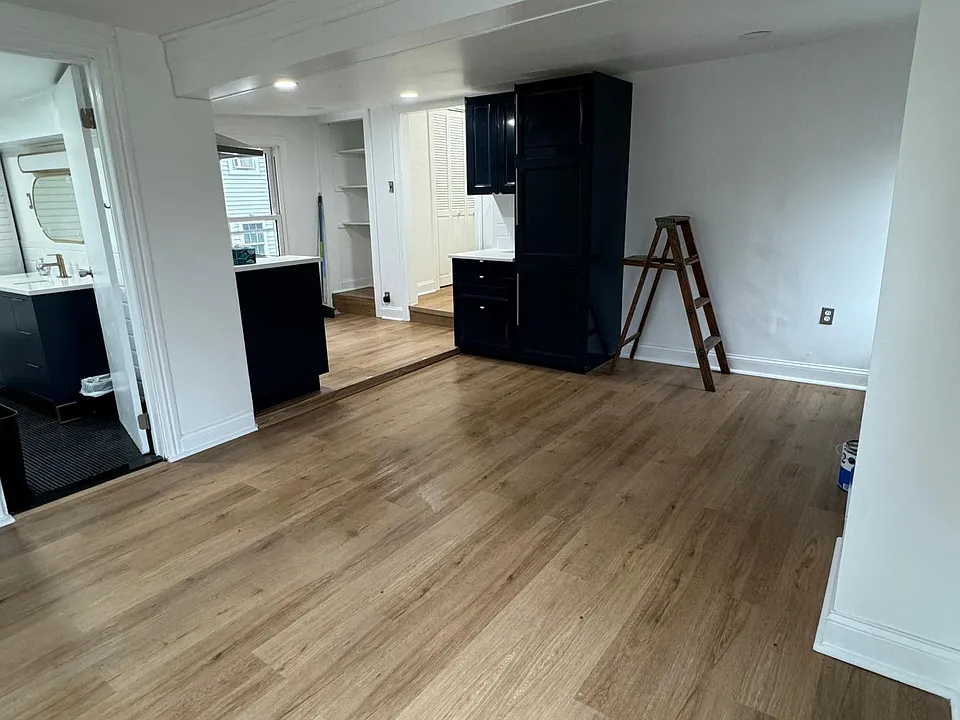 Living area, view from rear ,showing enclosed fridge and cabinet.
