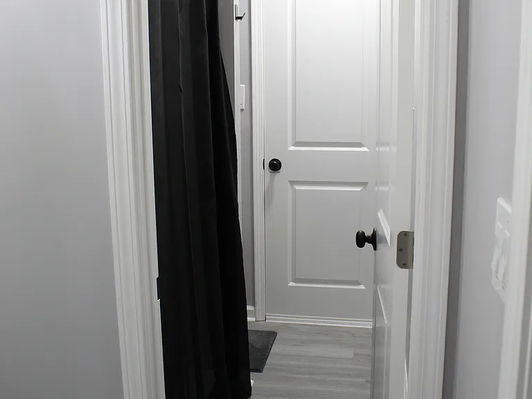 A walk-in shower and toilet cubby are adjacent the powder room.