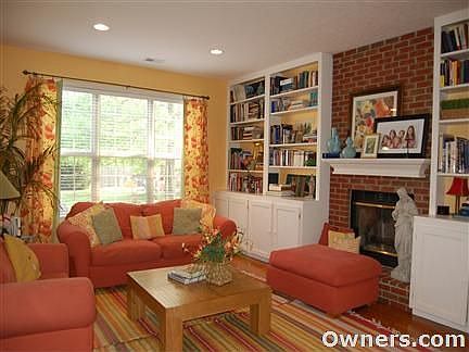 Family Room w/ brick fireplace & cabinetry