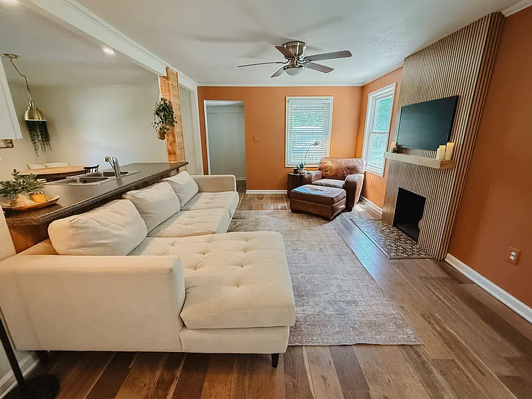 Comfortable leather sectional and armchair with ottoman