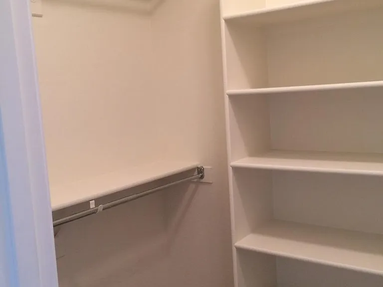 Primary bedroom walk-in closet
