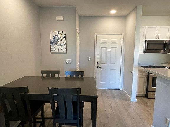 This unfurnished unit offers space for a standard dinner table for your dining area with the option to use high top bar seats instead to extend your living room area.