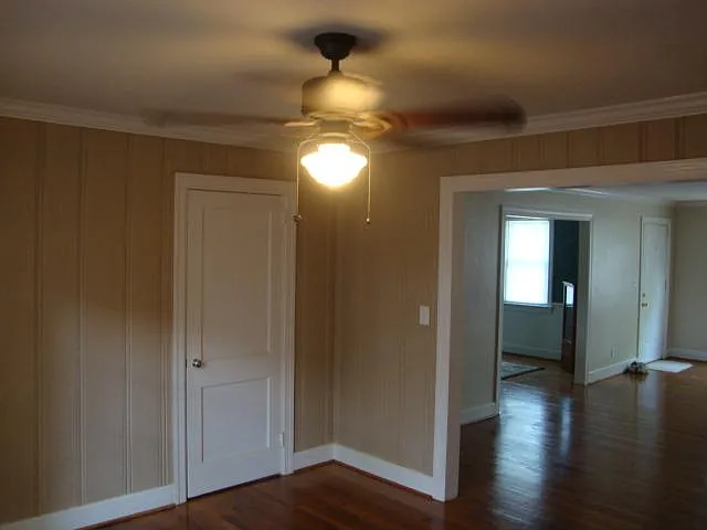 "3rd" bedroom/den view of kitchen entry door, dining room, and living room.