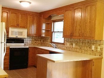 You will LOVE the spacious remodeled kitchen with oak cabinetry, tile backsplash, and updated appliances!