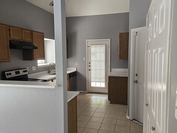 Washer and dryer room and exit to garage to the right.