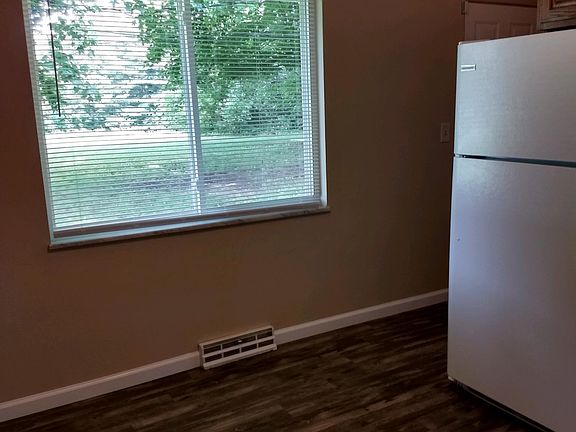 Kitchen has large window & has a mini blind.