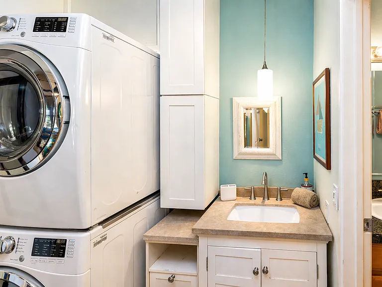 Washer/Dryer in hallway w/ extra vanity sink.