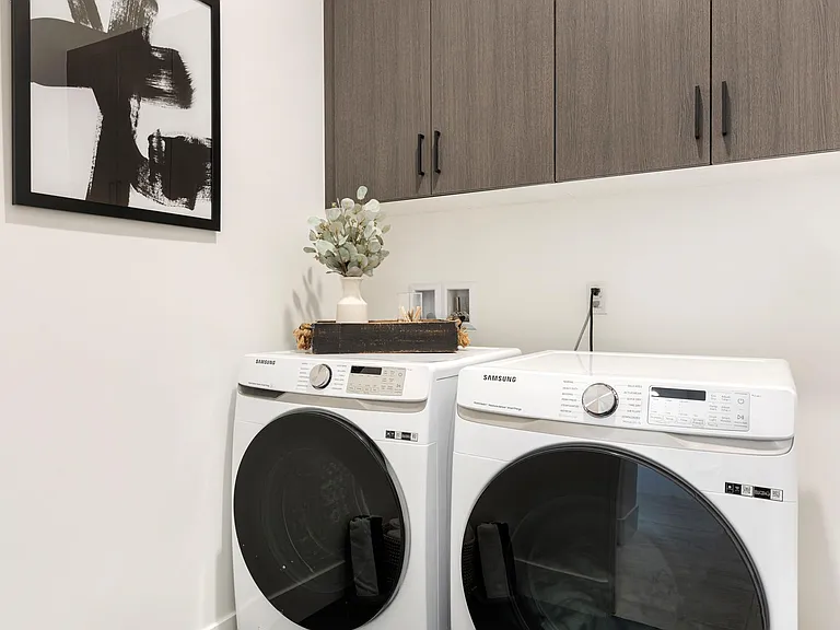 The laundry room is equipped with a matching washer and dryer to ensure you return home with clean clothes.