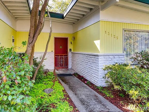 The entrance to the front door has wonderful charm.  The brick work you see here was done on purpose, as style that is appropriate for the era.  It's fun to see the cut out which lets the sun shine in.