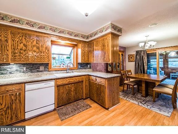 View of kitchen and dining room, out to 3 season porch.