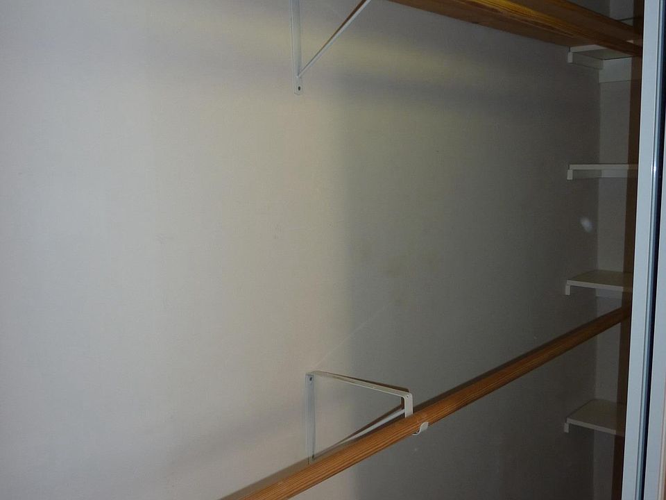 Large closet with double hangers, 2 shelves at either end.