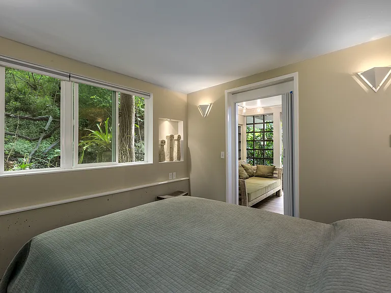 Third bedroom in the lower floor has queen bed adjacent to a lounge room