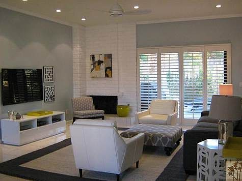 Living room with shutters, flatscreen TV.