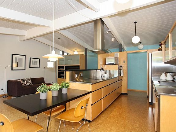 Modern Kitchen with stainless steal counters and cork floori