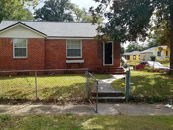 Front View from Street note the sidewalk and nice fenced yard on corner lot Garage in Back of house
