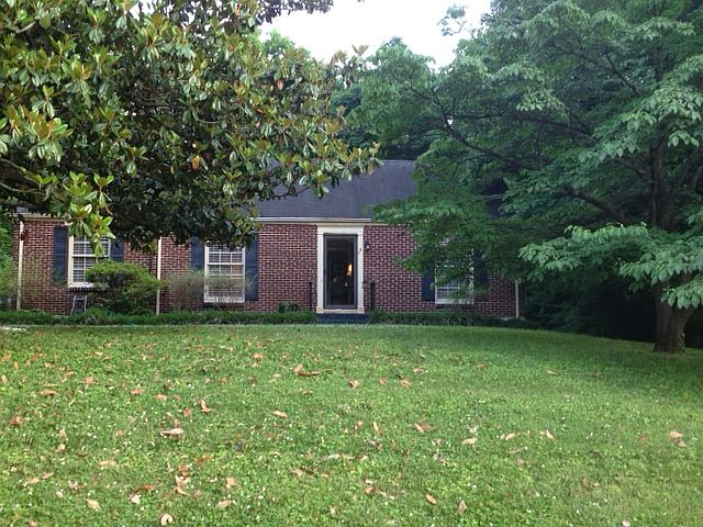 Front exterior with magnolia and dogwood trees