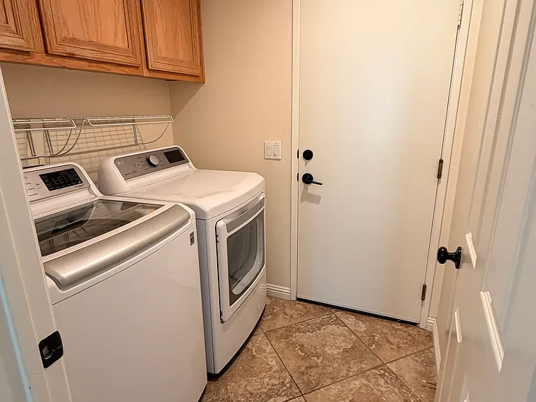Inside laundry room, which leads to the three car garage.