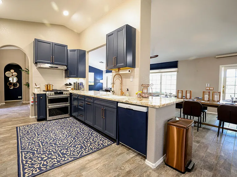 Kitchen with dbl oven GE CAFE gas stove, dbl sink, RO water filter with remineral cartridge, dishwasher, spices, utensils, granite stone cookware
