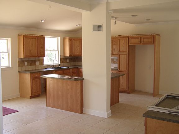 Huge kitchen with maple cabinets and ceramic tile.