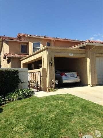 Front of property shows Courtyard entry, Garage and additional covered parking