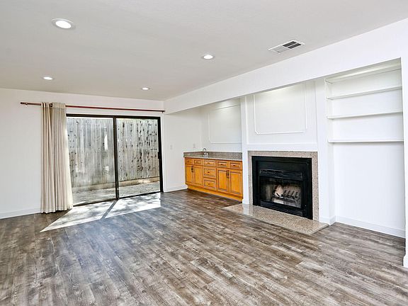 Living room with fireplace, wet bar and book shelf