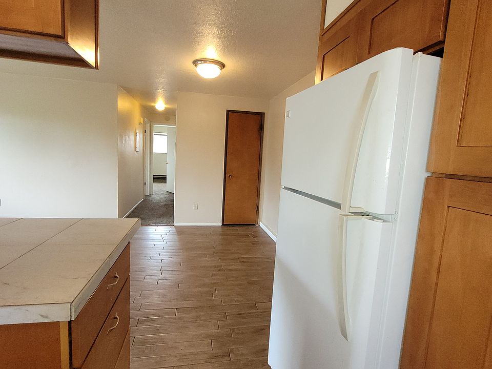 looking from kitchen into dining room at coat closet, and hallway to bedrooms and bathroom