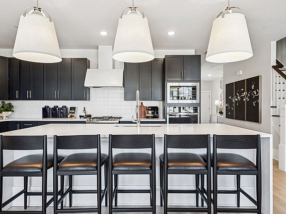 Kitchen with waterfall island and pendant lighting