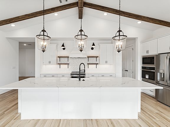 Kitchen with full-height tile backsplash