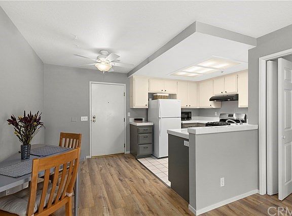 Another view looking from living area towards front door, dining and kitchen. You will be surprised by the amount of space in he