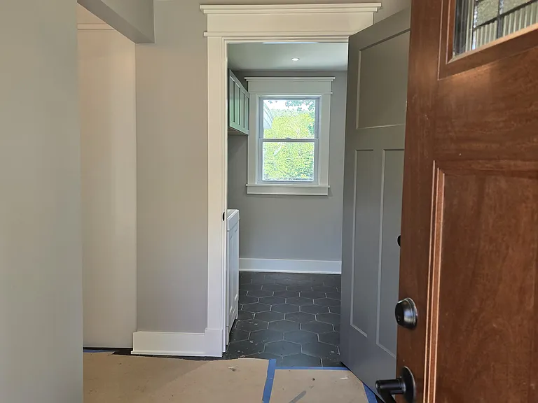 Entry which leads to kitchen left and laundry ahead.