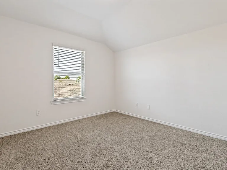 Room featuring neutral wall finishes and a single window with blinds