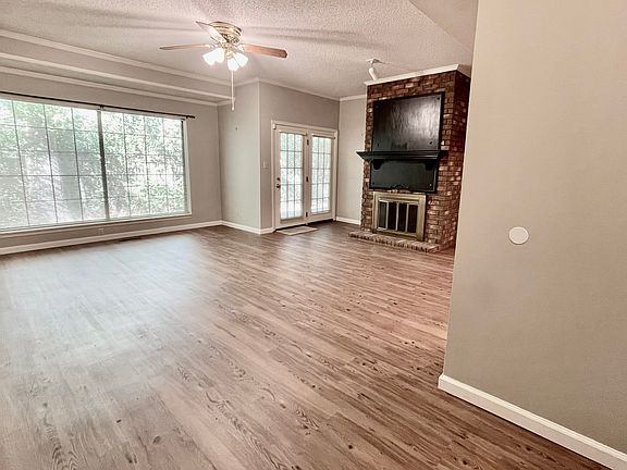 Large living room with fireplace w/gas logs awaits.