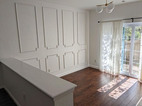 Patio doors lead to backyard with greenbelt view.