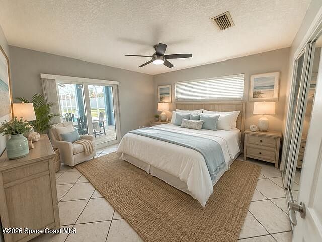 Serene primary bedroom, staged, with sliding-door access to the outdoors