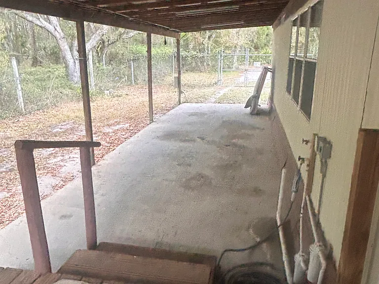 Back deck at kitchen entry and attached carport