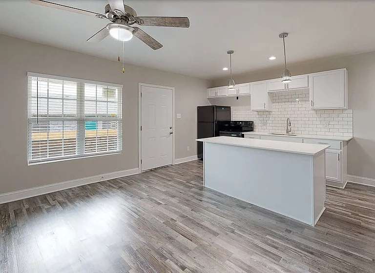 Beautiful bright natural light with ceiling fan and chef's kitchen