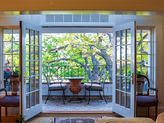 View from living room thru balcony to towering oak trees