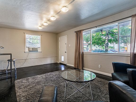 Living room has room for a desk on the far side. Also, there is a DOG DOOR!