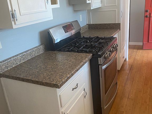 Bright and spacious kitchen with new countertops and freshly painted cabinets and walls with stainless steal stove, sink, and dishwasher