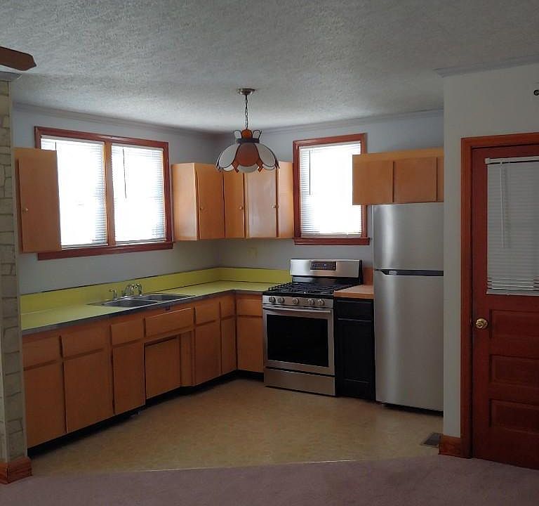 Kitchen with Stainless appliances with open concept with dining room.