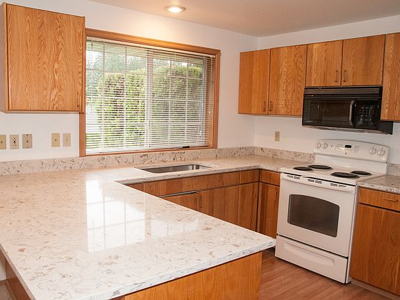Spacious kitchen with brand new countertops, sinks, and fauc