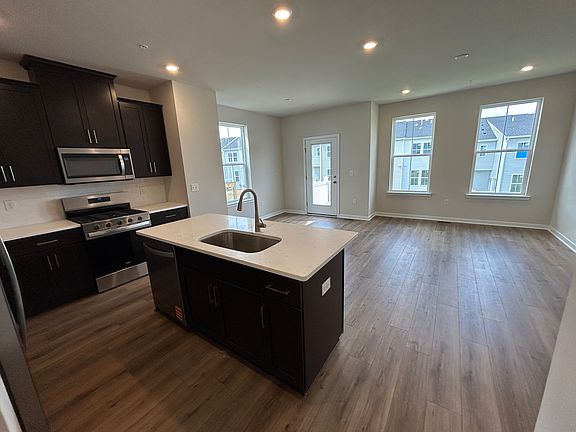 Open kitchen + living room with additional window for an end unit providing ample natural light