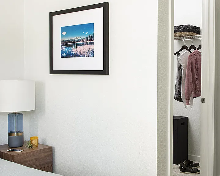 Spacious apartment Bedroom with Large Closet and Carpeted Floor.
