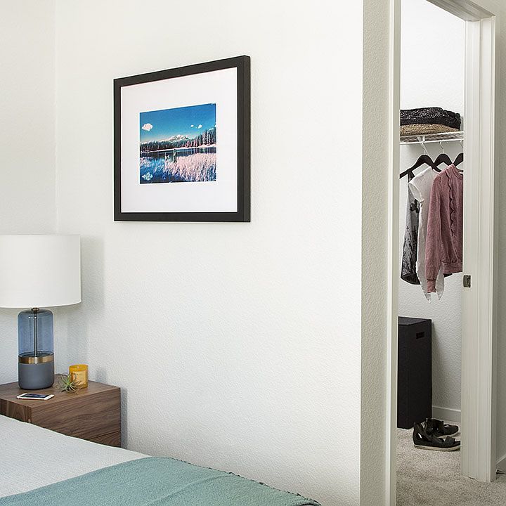 Spacious apartment Bedroom with Large Closet and Carpeted Floor.