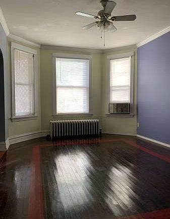 Older photo of living room . All 3 windows + built-in AC were replaced in early 2022.