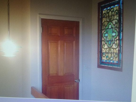 Central skylight behind stained glass allowing light to cond