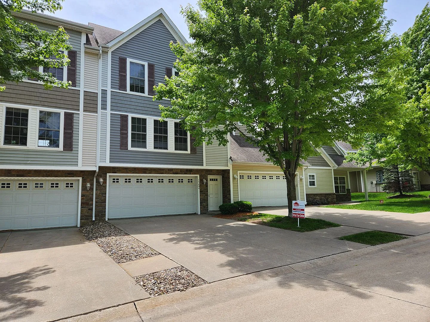 Now $1,550! Spacious Urbandale Townhome with 2-Car Garage & Lawn Care Included — Photo 1